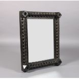 A VICTORIAN EBONISED WALL MIRROR, the degraded plate within a frame of quatrefoil pierced triangular