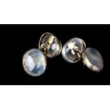 A PAIR OF MOONSTONE CUFFLINKS each face collet set with an oval cabochon and joined by trace links