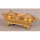 A REGENCY GILT BRONZE DESK STANDISH, rectangular with trefoil border and twin shell and 'c' scroll
