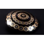 A VICTORIAN TORTOISESHELL PIQUE SHIELD BROOCH the graduated concentric rosette within a circular