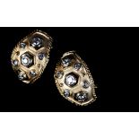 A PAIR OF DIAMOND EARRINGS the graduated brilliant cut stones collet set and raised above a