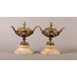 A PAIR OF 19TH CENTURY ORMOLU GARNITURE LIDDED VASES, the bodies with a pair of leaf clasped