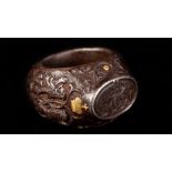 A LATE 19TH CENTURY STEEL AND GOLD HUNTING GLOVE RING, the oval head intaglio seal carved with RvM