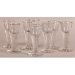 A SET OF EIGHT 19TH CENTURY SHOT OR TOASTING GLASSES with conical bowls, tapered stems and spreading