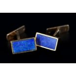 A PAIR OF LAPIS LAZULI SET CUFFLINKS in 9ct gold the rectangular collets set with a seal cut stone