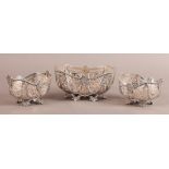 A VICTORIAN PAIR AND ONE LARGER SET OF THREE SILVER BASKETS, CHESTER 1895-7, of oblong form, the