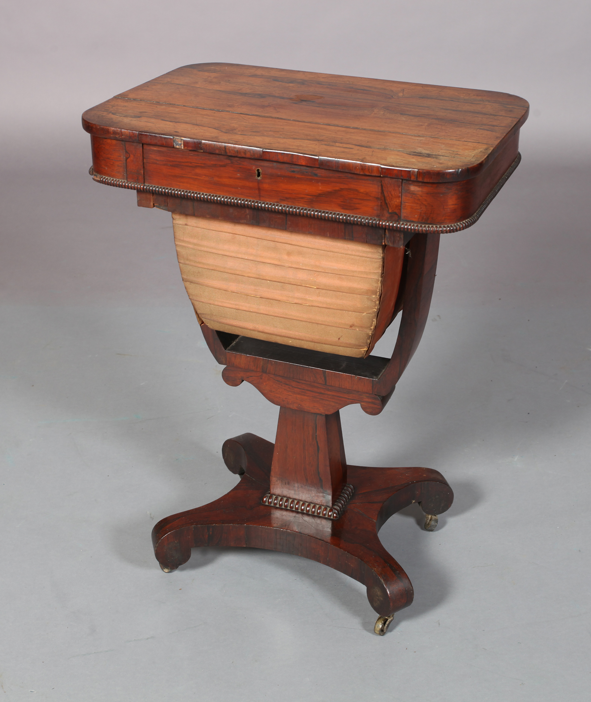 A WILLIAM IV ROSEWOOD VENEERED WORK TABLE, the rounded rectangular top fitted with frieze drawer and