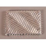 A VICTORIAN SILVER CARD CASE, London 1863, George Unite, rectangular, of wavy fluted design, the