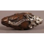 AN INTERESTING CHINESE COPPER AND SILVER OVERLAY BEAD cast with a mountainous landscape and script