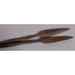 TWO AFRICAN HUNTING SPEARS with iron heads and wooden shafts, approximately 174cm long