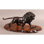 A JAPANESE BRONZE FIGURE OF A ROARING LION, Meiji period with tail outstretched and glass eyes, seal