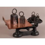 A PAIR OF EARLY 20TH CENTURY CAST IRON AND COPPER WEIGHING SCALES for parcels together with a set of