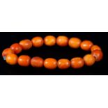 AN AMBER BRACELET of oval beads without fastener, approximate length 20cm, approximate weight 15gm