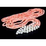 A SAUTIOR NECKLACE in coral and fresh water seed pearls as three strands of 4mm coral beads and