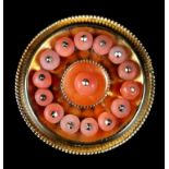 A MID VICTORIAN CORAL SET SHIELD BROOCH in 15ct gold, the 3mm coral beads post mounted to the centre