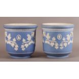 A PAIR OF WEDGWOOD BLUE JASPER WARE JARDINIERES, circular, sprigged with ram masks, oak leaf and ivy