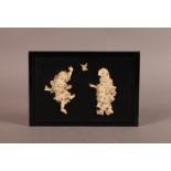 A JAPANESE EBONISED RECTANGULAR PANEL MOUNTED PAIR OF ENGRAVED AND INKED IVORY FIGURES and pair of