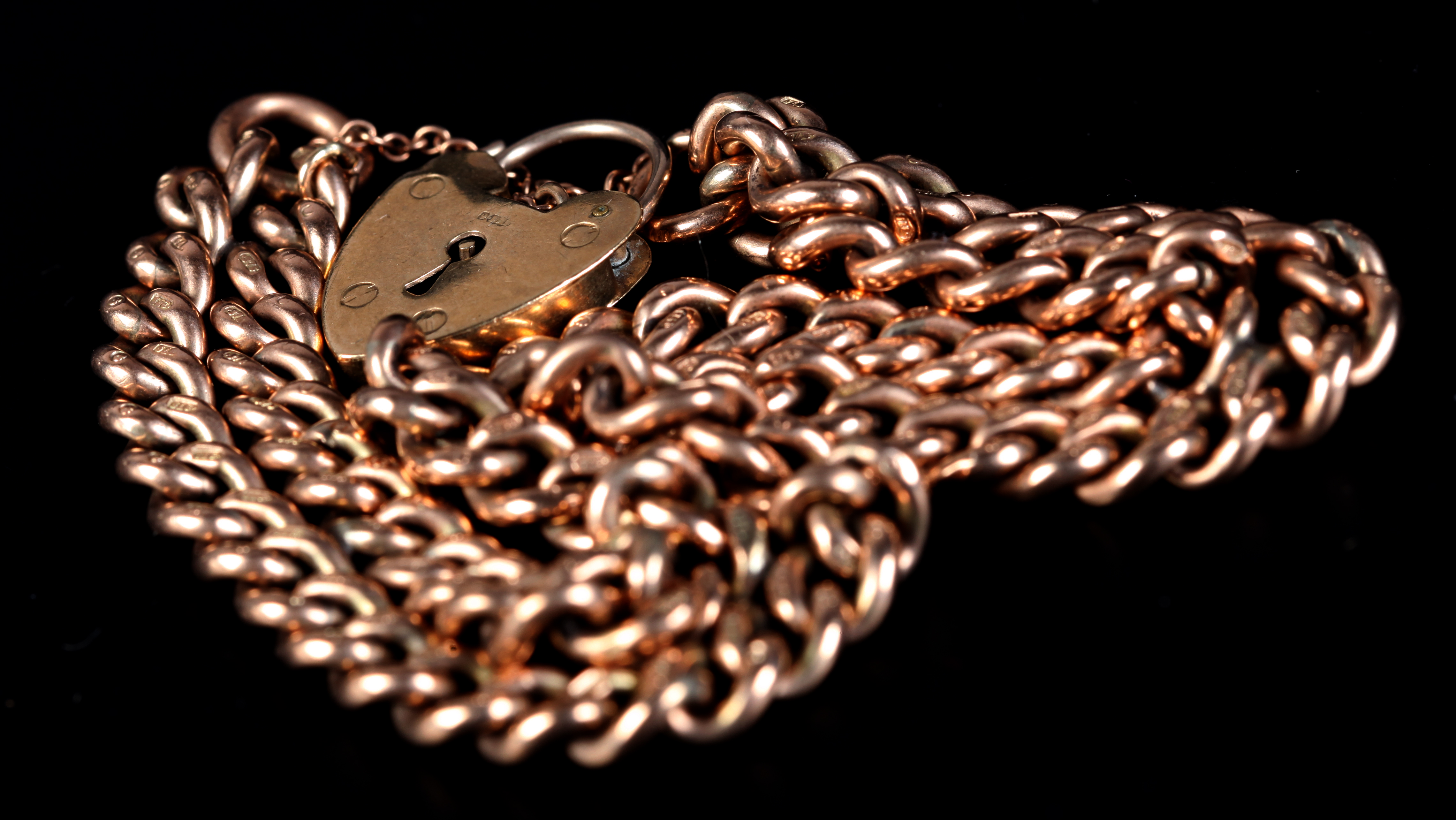 A BRACELET in 9ct rose gold of double curb links closed with a padlock fastener, total approximate - Image 2 of 2