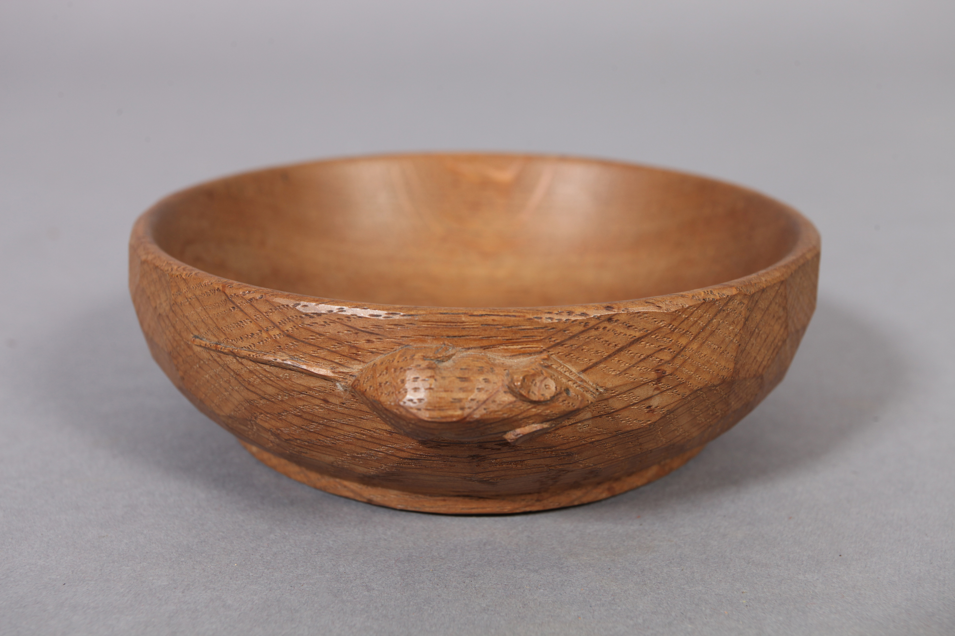 THOMPSON OF KILBURN 'MOUSEMAN', an oak small circular adzed bowl with shallow foot, carved with a