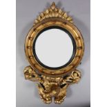 A REGENCY STYLE GILTWOOD WALL MIRROR, the convex glass within a black reeded slip, cavetto moulded