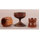 A LATE 18TH/EARLY 19TH CENTURY TURNED YEW-WOOD CUP on a conical foot, 6.5cm high together with a