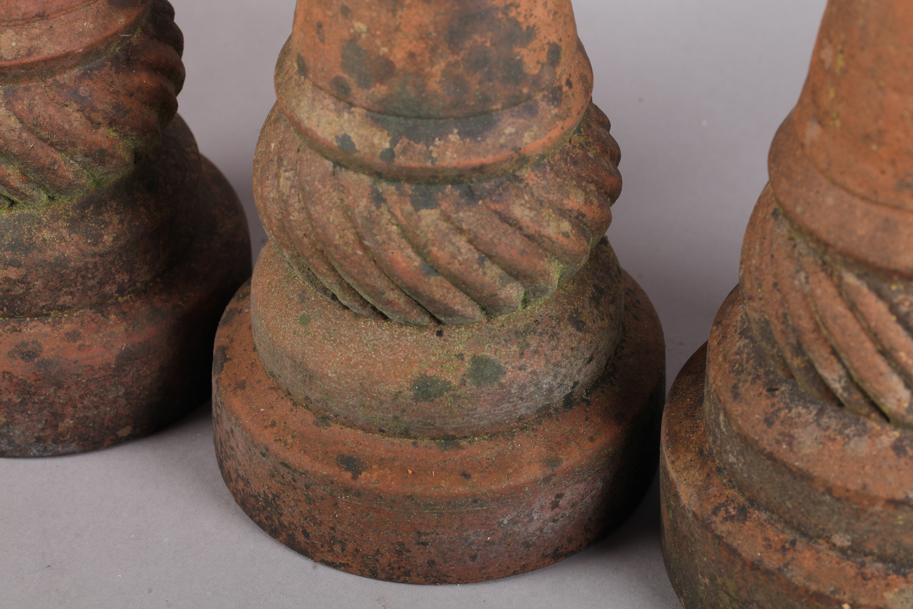 A SET OF THREE 19TH CENTURY TERRACOTTA FINIALS of conical and writhen form on circular plinth - Image 2 of 2