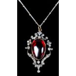 A VICTORIAN GARNET AND DIAMOND PENDANT in 9ct gold and silver the oval cabochon carbuncle collet