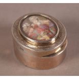 A GEORGE V OVAL SILVER GILT PILL BOX, the hinged lid inset with an oval miniature of sleeping seated