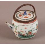 A CHINESE SQUAT BARREL SHAPED TEAPOT painted with a pair of panels of flowers and Koro within beaded
