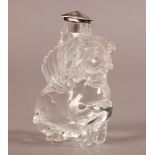 A CARVED GLASS GRIFFIN TYPE FIGURE OR SCENT BOTTLE with cut raised wings, fitted silver coloured