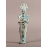 AN EGYPTIAN POTTERY USHABTI with hieroglyphics to the front panel, overall turquoise glaze, 18cm