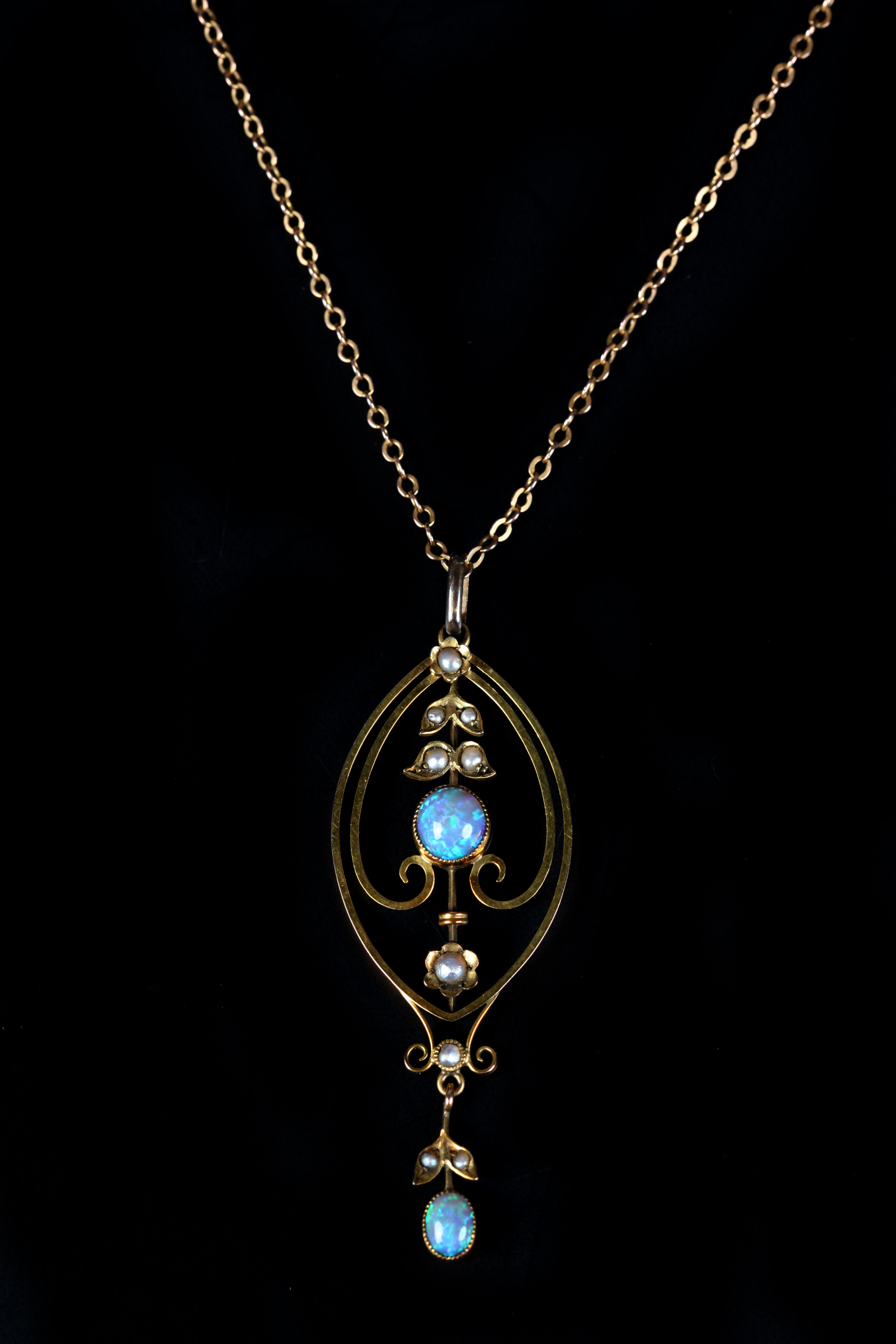 AN EDWARD VII OPAL AND SEED PEARL PENDANT in 9ct gold, the circular and oval cabochon opals collet