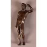 A BRONZE FIGURE AFTER THE ANTIQUE of a naked male youth standing with his left arm aloft, 11cm high,