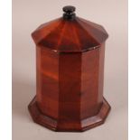 A 19TH CENTURY BANDED MAHOGANY CANISTER, decagon with conical cover and ebony finial, on chamfered