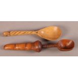 TREEN - A CARVED WOODEN SPOON with shovel shaped bowl and turned stem, the terminal finely carved as
