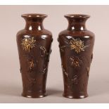 A PAIR OF JAPANESE PATINATED BRONZE OVOID VASES decorated with birds and chrysanthemums with gilt