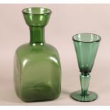 A LARGE GREEN GLASS FLASK OR VASE the square body with rounded shoulders, cylindrical neck with