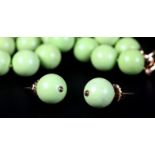 A STAINED TURQUOISE NECKLACE AND EAR STUD SUITE in lime green, the spherical 14mm beads and matching