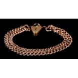 A BRACELET in 9ct rose gold of double curb links closed with a padlock fastener, total approximate