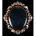 A VICTORIAN OVAL PICTURE PENDANT, the vacant glazed aperture to both sides within a pierced scroll