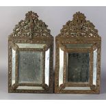 A PAIR OF 19TH CENTURY DUTCH BRASS WALL MIRRORS, embossed mounts, borders and clasps, mirror
