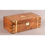 A VICTORIAN FIGURED WALNUT AND BRASS BOUND WRITING BOX the interior fitted with a maroon leather
