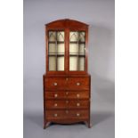 A REGENCY MAHOGANY SECRETAIRE BOOKCASE, line inlaid throughout with ebony stringing the arched top