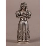 A 19TH CENTURY SILVER COLOURED METAL NEEDLE CASE in the form of a bride in ornate dress with veil,