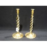 A Pair Of Circular Based Brass Twist Column Candlesticks