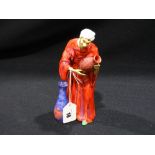 A Staffordshire China Figure, "Pot Seller" (AF)