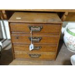 An Edwardian Oak Four Drawer Collectors Cabinet
