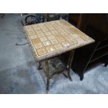 A Bamboo Framed Tile Topped Two Tier Table