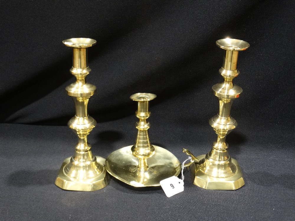 A Pair Of Antique Brass Candle Holders, Together With A Brass Chamber Stick