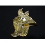 A Cast Brass Wall Plaque In The Form Of A Winged Helmet